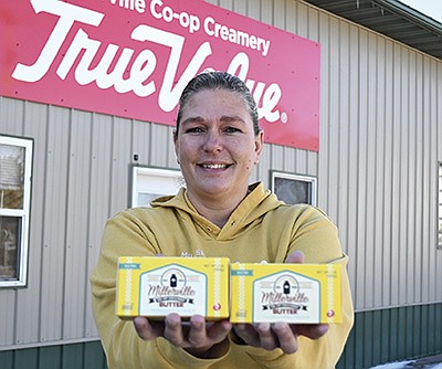 Deidre Hubbard shows the 1-pound blocks of butter made at Millerville Cooperative Creamery April 8 in Millerville, Minnesota. The creamery has made batch-made butter for 93 years. PHOTO BY JENNIFER COYNE