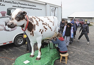 Children from Sheboygan Falls Elementary School get the opportunity to milk “Addie” the cow on the morning of May 5 during Classroom on the Farm at Majestic Crossing Dairy near Sheboygan Falls, Wisconsin. Nearly 1,000 students visited the farm. PHOTO BY STACEY SMART