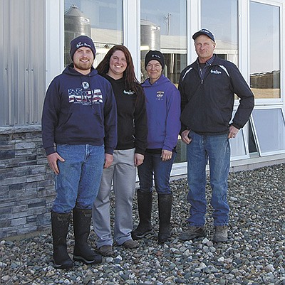 The Stempfle family – (from left) Scott, Scott’s fiancée, Alannah Gunther, Jody and Paul – milk 700 cows at Stempfle Holsteins near Maynard, Iowa. Paul and Scott both have received recognition for their work on the farm and in the industry. PHOTO BY SHERRY NEWELL