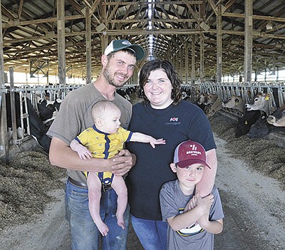 Brandon and Shannon Ehmke and their sons – (from left) Braylen and Parker – milk 240 cows and farm 275 acres near Hartford, Wisconsin. The Ehmkes began renting the farm Dec. 1, 2020. PHOTO BY STACEY SMART