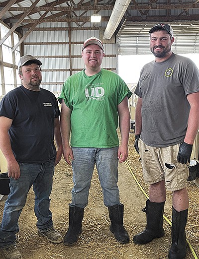 The Wolfs – (from left) cousins Scotty, Ryan and Ted – work at Wolf Dairy near Bankston, Iowa. Ryan began working for his uncle, James Wolf, and his wife, Kim, in 2015. James passed away in December.  PHOTO BY SHERRY NEWELL
