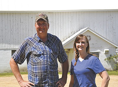Siblings, Bill and Keilah Powers stand in their family’s farmyard June 14 at their farm near Mauston, Wisconsin. The siblings, fifth generation dairy farmers, milk 32 cows, run a 30-cow beef herd, and Keilah manages the family candy business. PHOTO BY ABBY WIEDMEYER