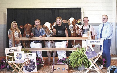 Wisconsin Ayrshire Queen Abby Charapata (from left), Kurt Wolf holding the intermediate and honorable mention grand champion cow Margot Precious, Michelle Wolf holding the reserve senior and reserve grand champion Miss Malibu Mimosa, Ryan Krohlow holding the senior and grand champion Palmyra Predator B Ruthless-ET and judge Kaleb Kruse are pictured at the Midwest National Ayrshire Show Aug. 2 in Fond du Lac, Wisconsin.  PHOTO COURTESY OF DAIRY AGENDATODAY