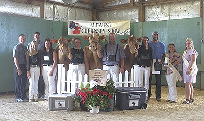 Judge Ryan Krohlow (from left), Lauryn Weisensel, Brandon and Kim Grewe, Haley Beukema holding the intermediate and honorable mention grand champion Dix Lee Kojack Don’t Doubt Me-ETV, Chad Ryan holding the reserve senior and reserve grand champion Balley Gem Hit It Devora, Megan Schrupp holding the senior and grand champion Knapps HP MB Trina-ETV, Tim Schrupp, Wisconsin Guernsey Princess Ashlee Garbers and National Guernsey Queen Raegan Kime are pictured at the Midwest Guernsey Show July 30 in West Salem, Wisconsin. PHOTO BY DANIELLE NAUMAN