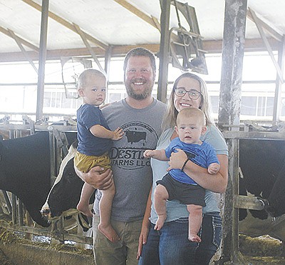 The Schuellers (from left) – Matthew holding Croix and Brittany holding Wren – operate Destiny Farms, LLC near Marshfield, Wisconsin. They milk 1,100 cows.  PHOTO BY DANIELLE NAUMAN