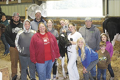 The Gerhardt family – (front, from left) Amy Gerhardt, Iris Vine holding her Holstein calf, Abby Backaus and Theamore Vine; (back, from left) are Dawson, Brady, Marty and Emily Gerhardt, Ashley Vine holding Alexander, Travis and Jocelyn Vine – enjoy taking part in the Clark County Fair in Neillsville, Wisconsin, each August. PHOTO BY DANIELLE NAUMAN