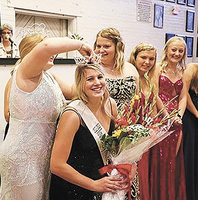 Naomi Scott is crowned the 69th Iowa Dairy Princess by the outgoing princess, Reagan Kime, Aug. 10 at the Iowa State Fairgrounds in Des Moines, Iowa. Scott and Kime are from Fayette County and have been close friends throughout their youth.  PHOTO BY SHERRY NEWELL