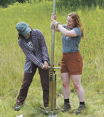 Mia Kaedy and Ashley Becker take a soil sample June 28 at the Grassland 2.0 Summit near Dodgeville, Wisconsin. Kaedy and Becker are graduate students at UW-Madison and discussed the importance of carbon to soil health.  PHOTO BY ABBY WIEDMEYER