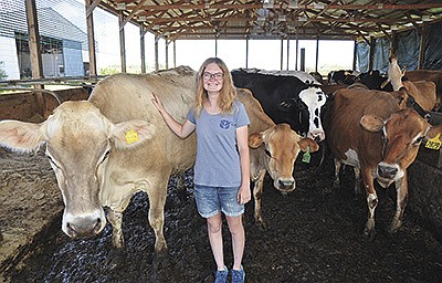 Ann Mallow stands among her herd on the farm she took over from her parents near Ixonia, Wisconsin. Mallow bought her parents’ cows and added to her existing herd. She is now milking 70 cows, while renting the land and buildings.  PHOTO BY STACEY SMART