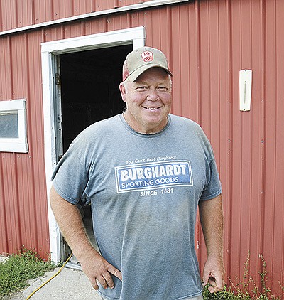 Patrick Smith milks 35 cows and farms 150 acres near Hartland, Wisconsin. He is also the manager of an amateur baseball team called the Monches Irish. PHOTO BY STACEY SMART
