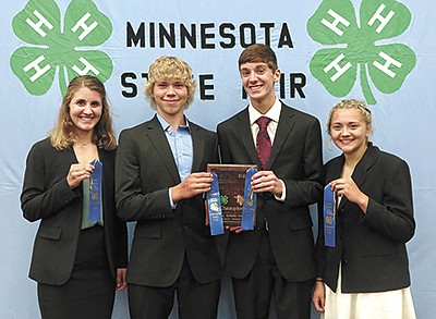 The Stearns County 4-H dairy judging team – (from left) Megan Ratka, Dan Frericks, Tyler Ratka and Lanna Walter – hold up their plaque and ribbons after winning the Minnesota 4-H Dairy Judging Competition at the Minnesota State Fair. The team will now travel to the World Dairy Expo in October to compete nationally.  PHOTO SUBMITTED