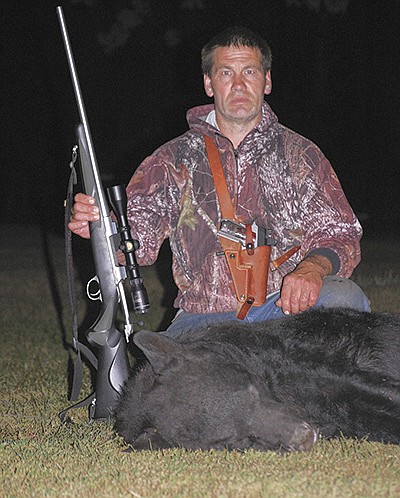 Peter-Mark Hendrickson poses Sept. 5 with a 320-pound bear he shot near his dairy farm by Menahga, Minnesota. PHOTO SUBMITTED