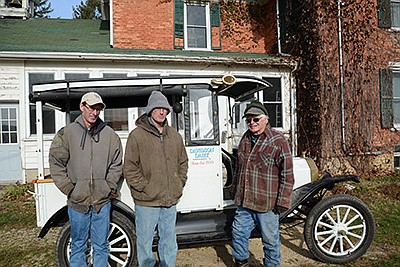 The Davidsons – Gary (from left), Andy and Richard – milk 134 cows between two farms and farm about 500 acres near Harvard, Illinois. Richard, an avid collector, restored his great-grandfather’s 1915 Model-T milk truck and lives on the farm his family purchased in 1889. PHOTO BY STACEY SMART