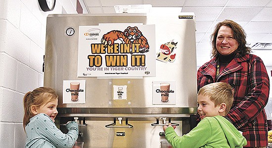 Kindergarteners Avalyn (left) and Korbyn choose chocolate milk while Lesli Mueller stands by the milk dispenser Nov. 30 at West Elementary School in Hutchinson, MInnesota. Mueller is the director of child nutrition for the district and helped bring a milk dispenser program to all schools there. PHOTO BY JAN LEFEBVRE