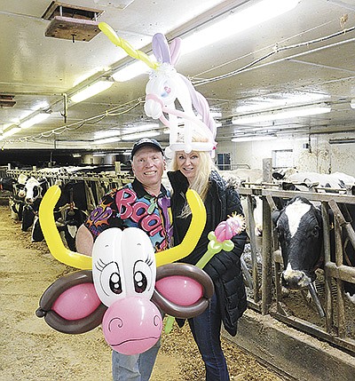 Mark and Judi Paul show off balloon sculptures that Mark makes as part of his business, NoBull Balloon Magic, Nov. 29 at their home near Luxemburg, Wisconsin. The Pauls milk 60 registered Holsteins on their 325-acre farm. PHOTO BY STACEY SMART