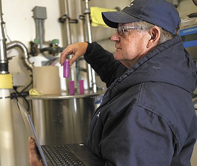 Chuck Lawrence checks a milk sample on a dairy farm Dec. 20 in southern Minnesota. At 70 years old, Lawrence has been a dairy inspector for over 28 years and does not plan to retire in the near future.  PHOTO SUBMITTED
