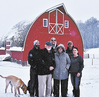 Shane (from left), Vincent, Stephen and Christine Maefsky along with Steven and Sarah Johnson stand together on a snowy Nov. 14, 2022, in front of the original barn on their property near Scandia, Minnesota. Poplar Hill Dairy Goat Farm milks 275 goats in a double-24 parallel pit parlor. PHOTO BY JAN LEFEBvRE