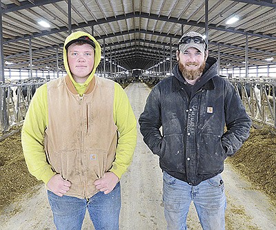 Cale Fedorski (left) and Nick Beck take a break Jan. 5 at Beck Dairy Farms near Allenton, Wisconsin. Fedorski is a senior at Kewaskum High School and has worked on the dairy since August 2021.  PHOTO BY STACEY SMART