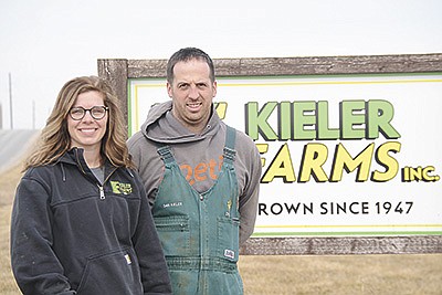 Leah and Dan Kieler stand by their farm sign Feb. 28 at their farm near Platteville, Wisconsin. The Kielers milk 2,000 cows and farm 4,500 acres.  PHOTO BY ABBY WIEDMEYER
