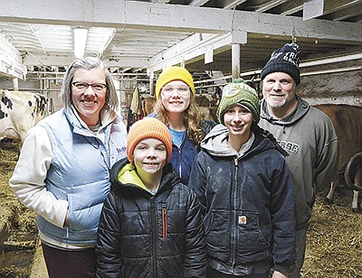 The Lichty family – Winston (front left); (back, from left) Dori, Vivian and Steve – milk 20 cows on their farm near Beaver Dam, Wisconsin. Pictured with the Lichty family is Sevanna Fairbank (front right), Vivian’s classmate and friend who has been helping on the farm since 2020. PHOTO BY STACEY SMART