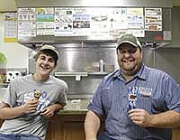 Caleb Speltz (left) and John Speltz enjoy free ice cream as part of a June Dairy Month promotion at Bonnie Rae’s Cafe in Rollingstone, Minn. Caleb is the son of Keith and Theresa Speltz, who milk 250 cows near Altura, Minn. John milks 700 cows also near Altura, Minn. <br /><!-- 1upcrlf -->PHOTO BY KRISTA KUZMA
