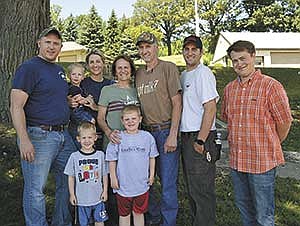Donna and Mike Tellers (center) along with their family – (from left) Dan Schmidt, Graham Schmidt, Heidi Schmidt holding Charlie Schmidt, Oliver Schmidt and Cory Tellers – and employee, Evan Carlson, hosted a farmer-to-farmer tour on their 47-cow dairy near Chaska, Minn. <br /><!-- 1upcrlf -->PHOTO BY KRISTA KUZMA