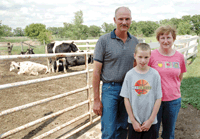 Marvin Thielen, (pictured with his wife, Judy, and his son, Brian) was one of the Stearns County dairy producers who attended the CapX  2020 open house Tuesday, Sept. 25 at the Melrose American Legion. Thielen’s 68-cow Melrose, Minn. farm is situated beside Interstate 94 and is within one of the possible transmission line routes identified for the proposed project. (photo by Kristen J. Kubisiak) 