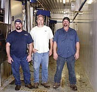 The Kriener brothers, from left, Jeremy, Arlen and Peter, started milking with robotic milkers in February. They switched from milking 135 cows in a 44-stanchion barn with six automatic take-offs to milking 238 cows with four robotic milkers. The Krieners dairy farm near Fort Atkinson, Iowa.<br /><!-- 1upcrlf -->PHOTO BY KELLI BOYLEN
