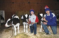 Mitchell (left) and Mandy Molitor (right) welcomed their family’s second set of triplet heifers calves in 10.5 years on Nov. 20, 2012, which also happens to be Mandy’s birthday.<br /><!-- 1upcrlf -->PHOTO BY ANDREA BORGERDING