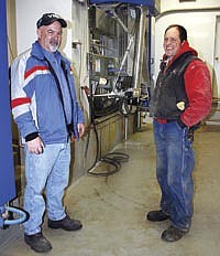 Dave Melchert (left) of United Suckow Dairy Supply worked with Scott Adams and his son, Nathan (not pictured) to install two robotic milking units last winter and another two this winter.<br /><!-- 1upcrlf -->PHOTO BY KELLI BOYLEN