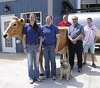 The Maxwells will showcase their new facility during an open house on June 15 at their dairy farm near Donahue, Iowa. The Maxwells are pictured, from left, Kara, Amy, John, Ed and Boris Ivolga.<br /><!-- 1upcrlf -->PHOTO SUBMITTED