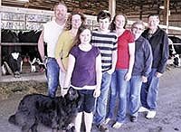 Three generations in the Kulzer family stand inside their barn on their farm in Stearns County near Greenwald, Minn. Pictured (far right) Dorine and Ken Kulzer; and (from left) their son Mike and wife Julie and their children, Lauren, Josh and Rachael. <br /><!-- 1upcrlf -->PHOTO BY CAROL MOORMAN