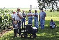 Bernard Runde (with the microphone) hosted a weed control field day on his 90-cow organic farm near Cuba City, Wis. The corn behind him was planted May 18 and stood nearly six feet tall on July 10.<br /><!-- 1upcrlf -->PHOTO BY RON JOHNSON