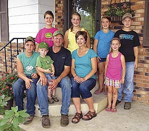 Rick and Becky Helget have seven children. Pictured front, from left: Dominic; Ethan; Rick, Becky and Josie. Back row, from left: Molly; Megan; Emily; and Anthony.  Not pictured: Elise, 18, who is studying to be a physical therapy assistant at Lake Area Tech in Watertown, S.D. The Helgets milk 65 Holstein cows on their organic dairy in Watonwan County near St. James, Minn. All the children attend St. Mary’s Catholic School in Sleepy Eye, Minn.<br /><!-- 1upcrlf -->PHOTO BY RUTH KLOSSNER