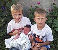 Ira (left) and Dane (right) are pictured with their new brother, Henry Peter Davison, born at 5:17 p.m. on Aug. 17.<br /><!-- 1upcrlf -->PHOTO BY JAcQUI DAVISON