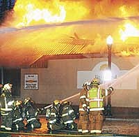 Firefighters work on putting out a fire that destroyed Unionland Feed and Supply on Nov. 5. in West Union, Iowa. The fire started in the back of the feed store. <br /><!-- 1upcrlf -->Photo by Jerry Wadian, Fayette County Union