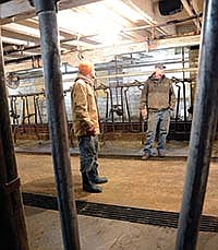 Chris (left) and Jason bought the dairy on Aug. 1, 2012. One of their first tasks was changing the barn over to a double-10 flat parlor, which includes headlocks on one side and stanchions on the other. <br /><!-- 1upcrlf -->PHOTO BY MARK KLAPHAKE