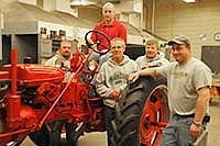 Holdingford Alumni chapter board members, (from left) Ed Young, Jeff Symanietz, Dan Skwira, Joe Zachman and John Roberts, stand with a tractor donated by Stanley Symanietz. The tractor is in the midst of restoration at Holdingford High School. <br /><!-- 1upcrlf -->PHOTO BY LIZ VOS