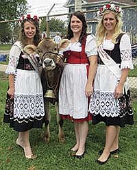 Cheese Days Ambassador, Sarah Sacker, Kelsi Mayer, and Cheese Days Ambassador, Breinne Hendrickson, wear traditional Swiss dresses in the parade on Sept. 21.<br /><!-- 1upcrlf -->PHOTO BY NICOEL SMITH