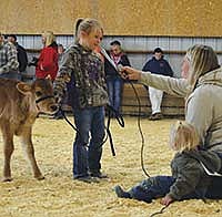 Gracey Wubbenhorst and her calf Minnie stop to talk with Gale Klinkner and her daughter, Rubi, during the Little Britches show Sept. 12 at the Vernon County Fair.<br /><!-- 1upcrlf -->PHOTO BY LABECCA SCHOTT