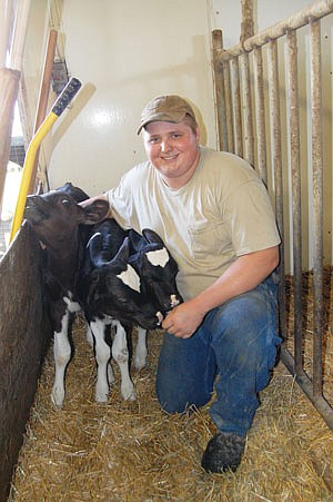 Keith Fasching is pictured with his triplet heifer calves that were born on July 18. The calves were born to a 7-year-old cow, and both cow and calves are doing well. Fasching milks around 60 cows in a rented facility near Silver Lake, Minn. (photos by Jennifer Burggraff)