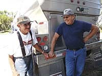 Merle Pearson shares a pleasant chat with Tim Newton, his First District Association milk truck driver. Pearson has milked cows for nearly seven decades and says that the social aspect of dairy farming is the main thing that keeps him going.