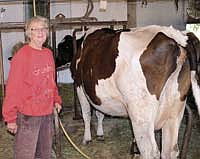 Irene Hiltner milks one of her 13 cows in a dairy barn she and her late husband, Melvin, built in 1971. Milking has always been Irene’s job on the farm, ever since they started dairy farming in 1971, and it’s a job the 73-year-old doesn’t plan to quit any time soon.<br /><!-- 1upcrlf -->PHTOO BY MARK KLAPHAKE