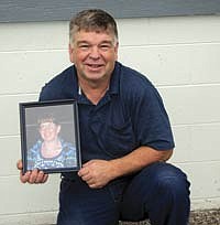 Tom Mitchell holds a picture of his wife, Dawn, who passed away on June 17 of this year after a four-year battle with breast cancer. <br /><!-- 1upcrlf -->PHOTO SUBMITTED