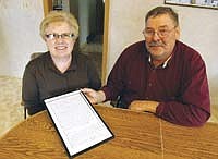 Sharon and Jim Tentinger hold a copy of the deed to their farm, which was purchased by Jim’s great-grandfather in 1882. The Tentingers, who have a 180-cow registered Ayrshire operation, have been very active in the show ring and are strong promoters of the dairy industry.<br /><!-- 1upcrlf -->PHOTO BY JERRY NELSON