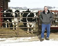 Myron Schneider paused after checking on a group of heifers on the family dairy.<br /><!-- 1upcrlf -->PHOTO BY RUTH KLOSSNER