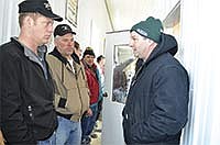 Marvin Rohe, right, shares with fellow dairy farmers the benefits he has seen since using the automated calf feeder during a robotics tour on April 16.<br /><!-- 1upcrlf -->PHOTO BY MISSY MUSSMAN