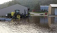 Water flooded part of Duschee Hills Dairy near Lanesboro, Minn. Although the herd of cows was able to be milked on time, the flood waters from June 22 and 23 left mud and debris to clean up, along with flooded fields. <br /><!-- 1upcrlf -->PHOTO SUBMITTED