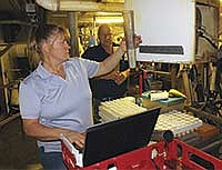 Daryl brings sample tubes to Cheryl as they tested cows at Brockshus Dairy near Ocheyedan, Iowa. Their day started at 3 a.m. and they didn’t finish with the morning’s testing until about 11 a.m. Brockshus Dairy has 400 cows.<br /><!-- 1upcrlf -->PHOTO BY JERRY NELSON