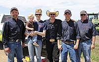 Farm Rescue volunteers – (from left) Faron Wahl, regional operations manager; Carol Wielenga, holding her son, Lincoln (22 months); Carol’s husband, Levi Wielenga; his brother, Lorn Wielenga; and Jack Rutledge from Georgia – attended a planter clinic put on this spring by RDO Equipment Company. Farm Rescue volunteers go through rigorous training before they are allowed to operate any equipment.<br /><!-- 1upcrlf -->PHOTO SUBMITTED